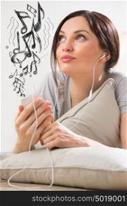 Woman listening to music using her smartphone at home