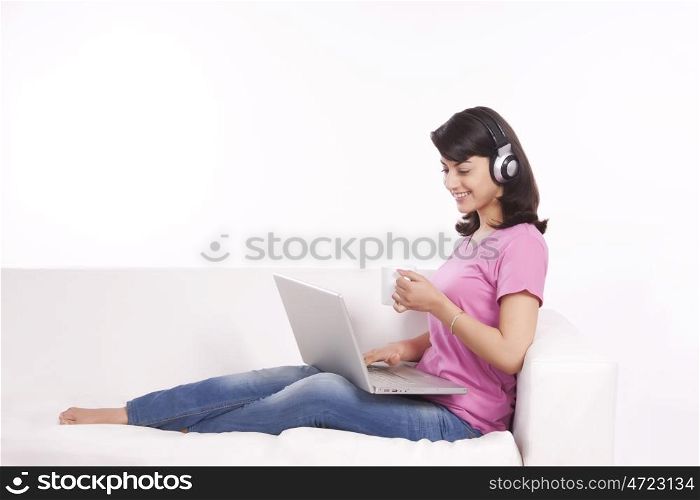 Woman listening to music while having tea