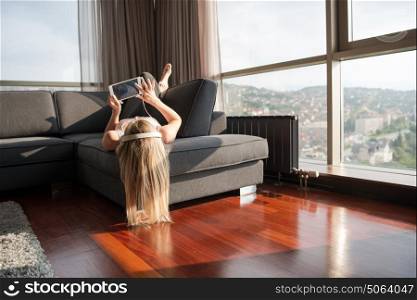 woman listening to music with sun flare coming from window of apartment
