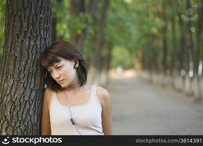 Woman listens to personal stereo in public park