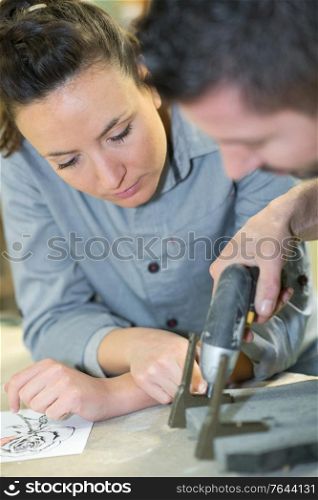 woman looking a at a drill in hardware store