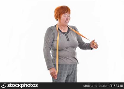 Woman looking a measuring tape isolated on white background
