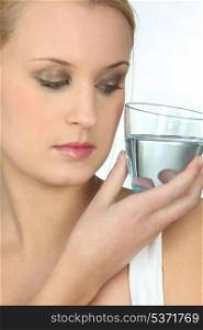 Woman looking at a glass of water