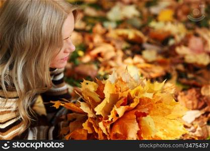 Woman looking at autumn leaves