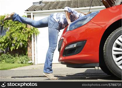 Woman Looking At Car Engine With Head Disappearing Under Hood