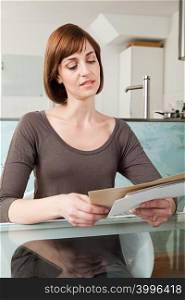 Woman looking at envelopes