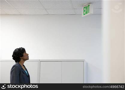 Woman looking at exit sign