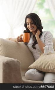 Woman looking at her mug of tea