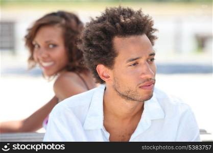 Woman looking at her pensive boyfriend