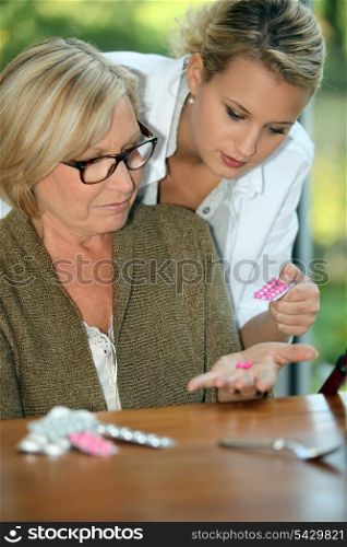 Woman looking at her pills