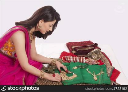 Woman looking at jewelery and wedding attire