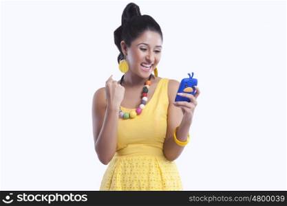 Woman looking at mobile phone and rejoicing