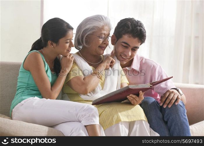 Woman looking at photo album with grandchildren