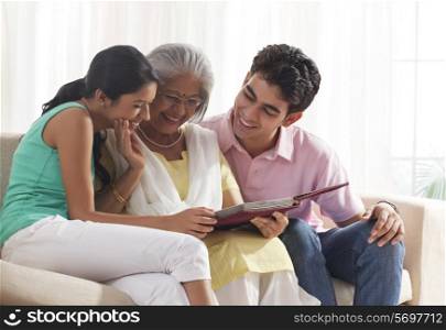 Woman looking at photo album with grandchildren