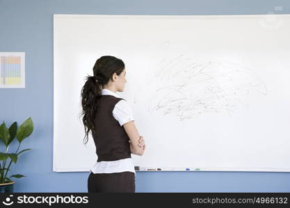 Woman looking at scribble on whiteboard