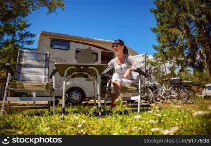 Woman looking at the laptop near the camping . Caravan car Vacation. Family vacation travel, holiday trip in motorhome. Wi-fi connection information communication technology.