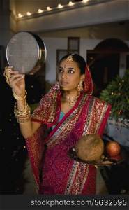 Woman looking at the moon during Karva Chauth