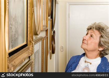 Woman looking at wall of photographs