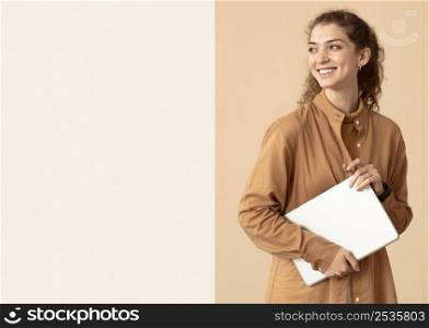 woman looking away holding laptop copy space