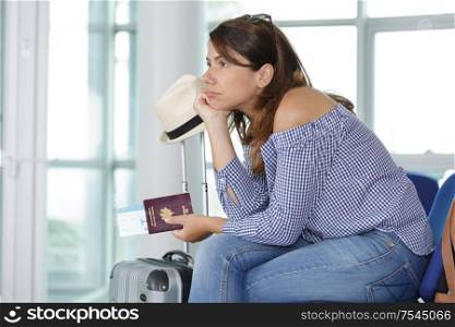 woman looking bored waiting for her flight