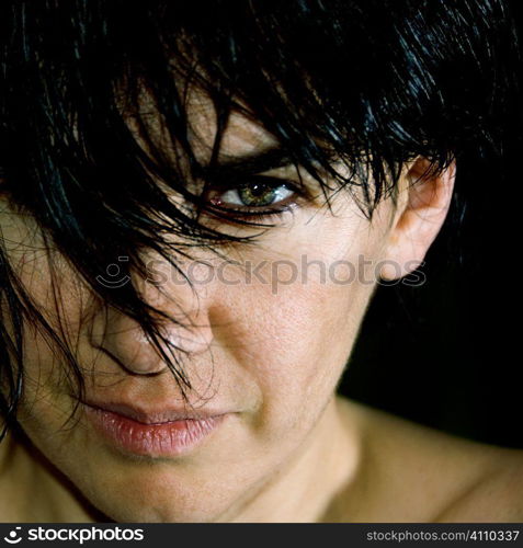 Woman looking directly at camera under black fringe