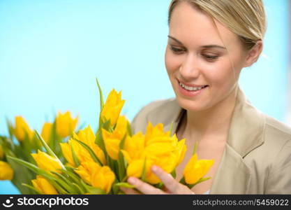 Woman looking down spring yellow flowers hold bouquet of tulip