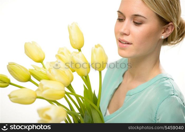 Woman looking down yellow tulip spring flowers isolated on white