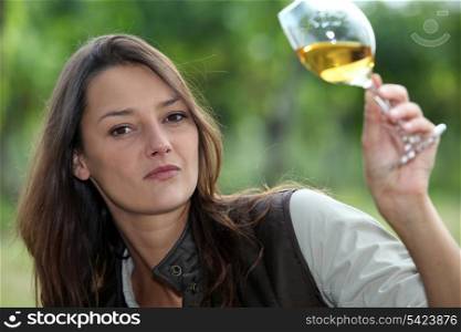 Woman looking glass of wine