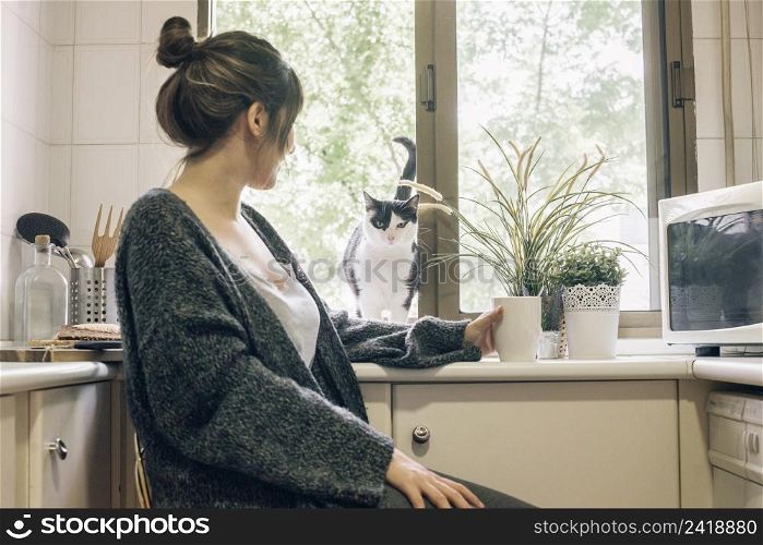 woman looking her cat kitchen