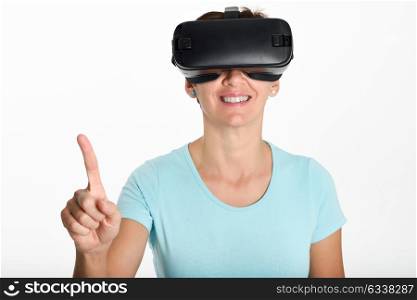 Woman looking in VR glasses and gesturing with his hands. Beautiful surprised female wearing virtual reality goggles watching movies or playing video games, isolated on white background.