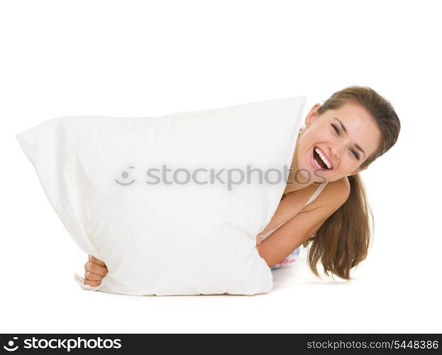 Woman looking out from pillow isolated on white