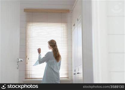 Woman Looking Out Window