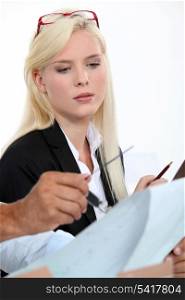 Woman looking over paperwork with colleagues