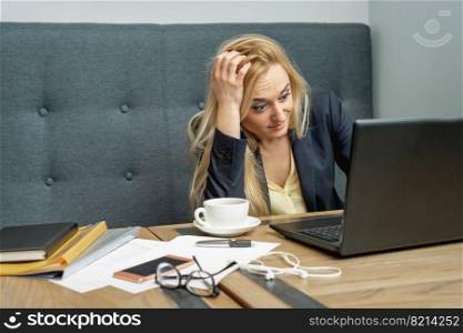 Woman looking surprised while using the laptop at the workplace at home.. Woman looking surprised while using the laptop.