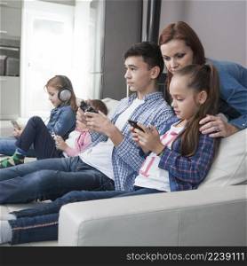 woman looking teenager girl playing video games