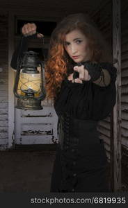 Woman looking with an old fashoned lantern