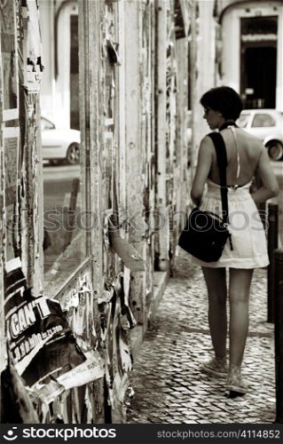 Woman looks in Lisbon shop windows