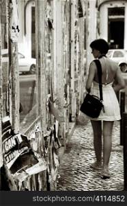 Woman looks in Lisbon shop windows