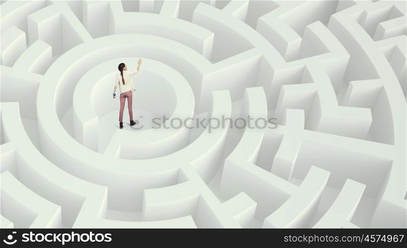 Woman lost in maze Mixed media. Young woman in center of white labyrinth trying to find way out