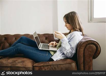 woman lounging with coffee laptop