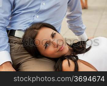 woman lying at mans knees at outdoor