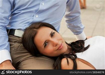 woman lying at mans knees at outdoor