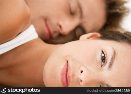 Woman lying down close up man in background