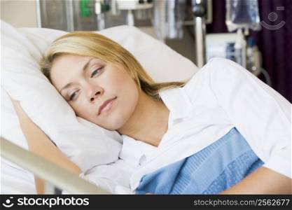 Woman Lying Down In Hospital Bed