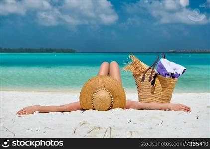 Woman lying down on beach. Summer vacation at Maldives.