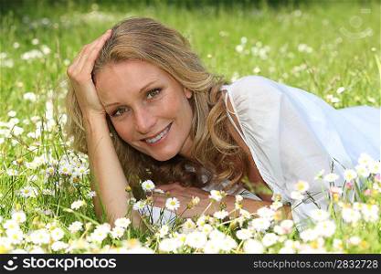 Woman lying in a grassy field