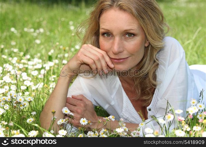 Woman lying in a grassy field
