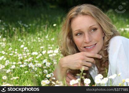 Woman lying in a meadow