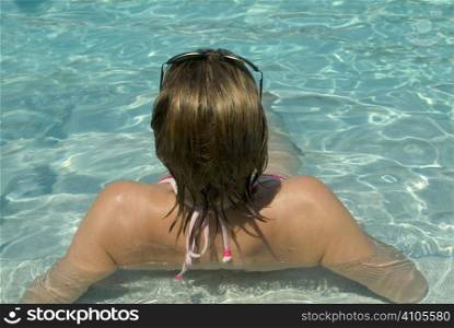 woman lying in a swimming pool relaxing