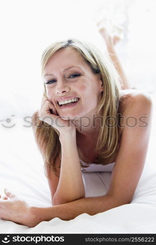 Woman lying in bed laughing